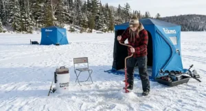 A beginner-friendly ice fishing setup featuring a lightweight auger, sled, and pop-up ice shack.