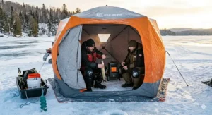 Two anglers ice fishing in March; one in an insulated shelter protected from the "hard water" elements and damp spring conditions.