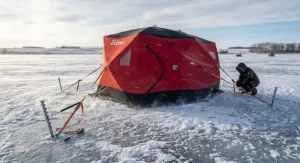 A hub style ice shelter secured with heavy-duty ice anchors against high winds on the Canadian Prairies.
