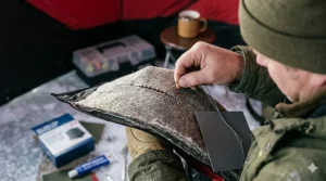 Alt text for image 3: Step-by-step diagram showing how to fix a tear in a thermal ice fishing tent wall.