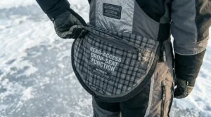 Child wearing youth-sized insulated bibs for ice fishing during a family fishing derby in Ontario.