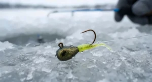 Close-up of a panfish jig rigged with soft plastic bait for ice fishing.