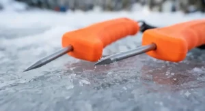 Close-up of the sharp steel spikes on heavy-duty ice fishing picks designed for gripping slippery winter ice.