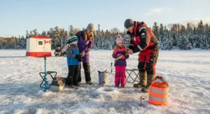 A family enjoying safe ice fishing in Canada with a brightly colored ice fishing rescue rope kept securely nearby for winter recreation.