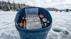An open ice fishing bucket revealing organized tackle boxes, lures, and ice fishing accessories.